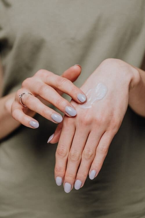 Handmade balm with fresh botanicals on a linen surface